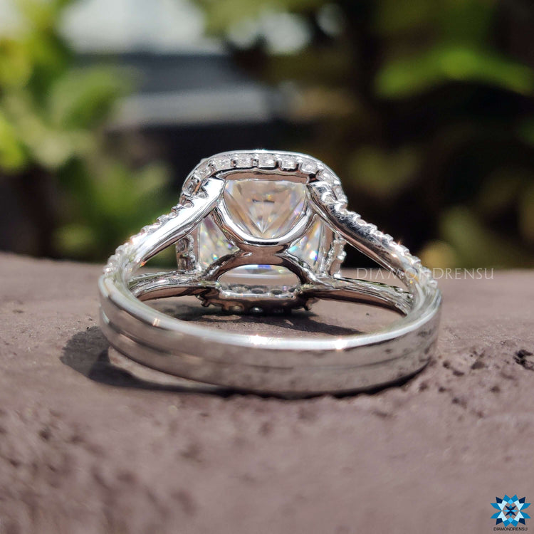 Hidden halo cushion moissanite ring with prong setting.
