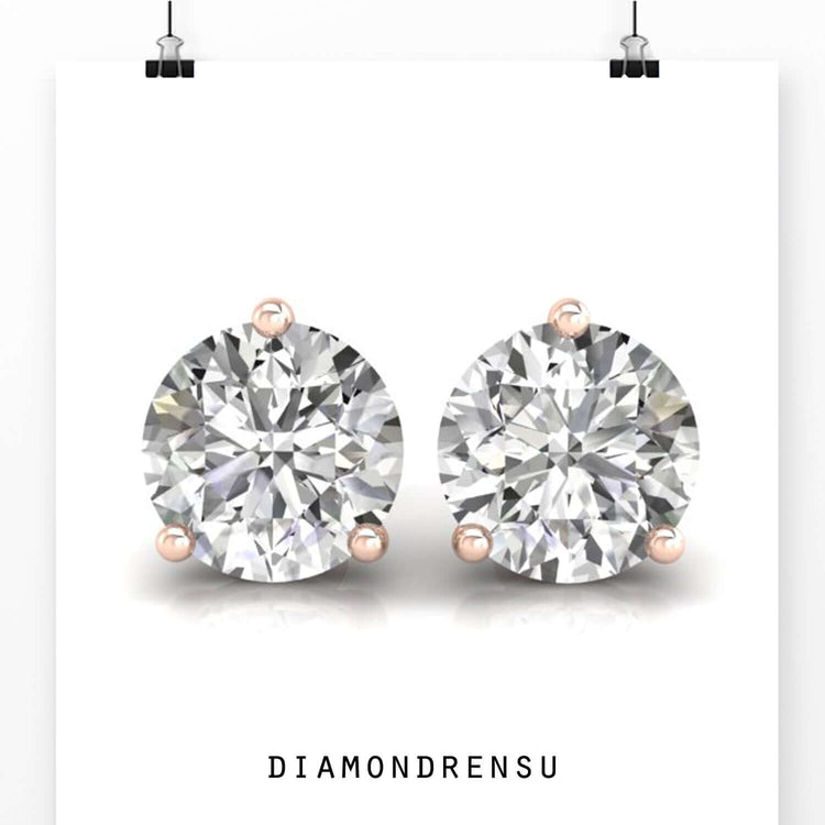 Gold diamond earrings with round cut stones and screw back closure.
