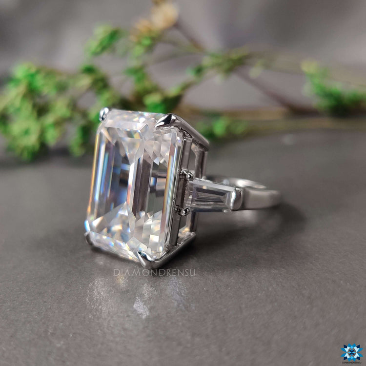 White gold ring featuring three moissanite stones.
