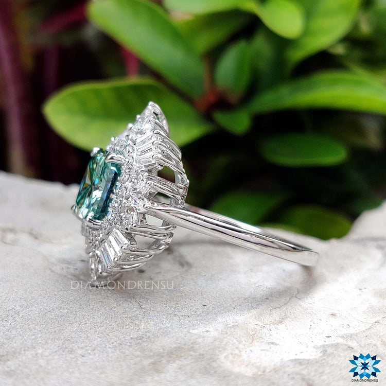 Radiant cut moissanite ring with prong and halo setting.

