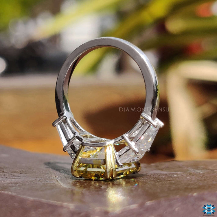 Canary yellow moissanite set in a two tone band.
