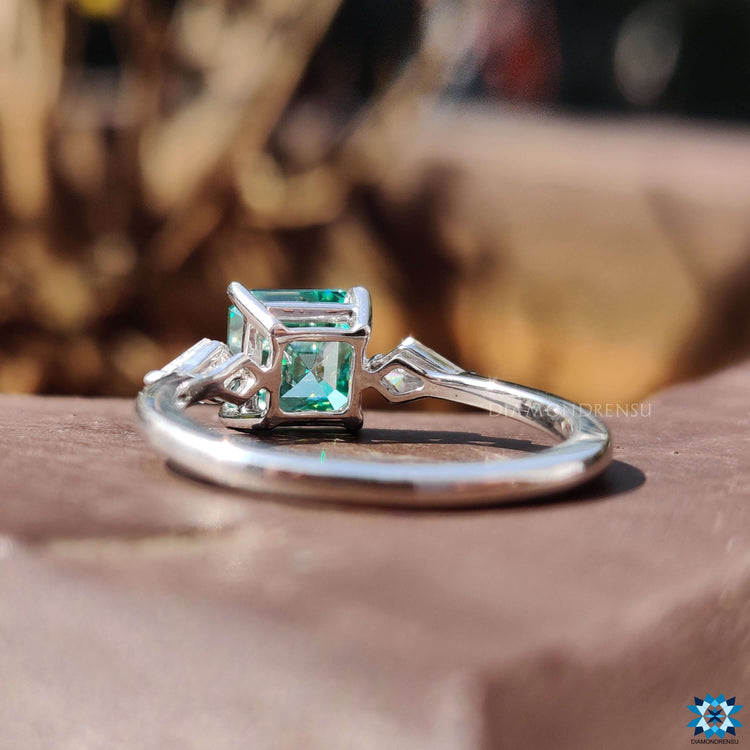 4 prong setting ring with green Asscher cut moissanite.
