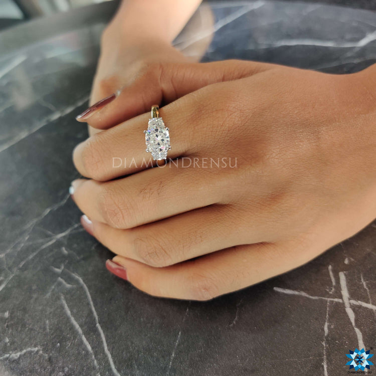 Cushion cut three stone ring set in claw prongs.
