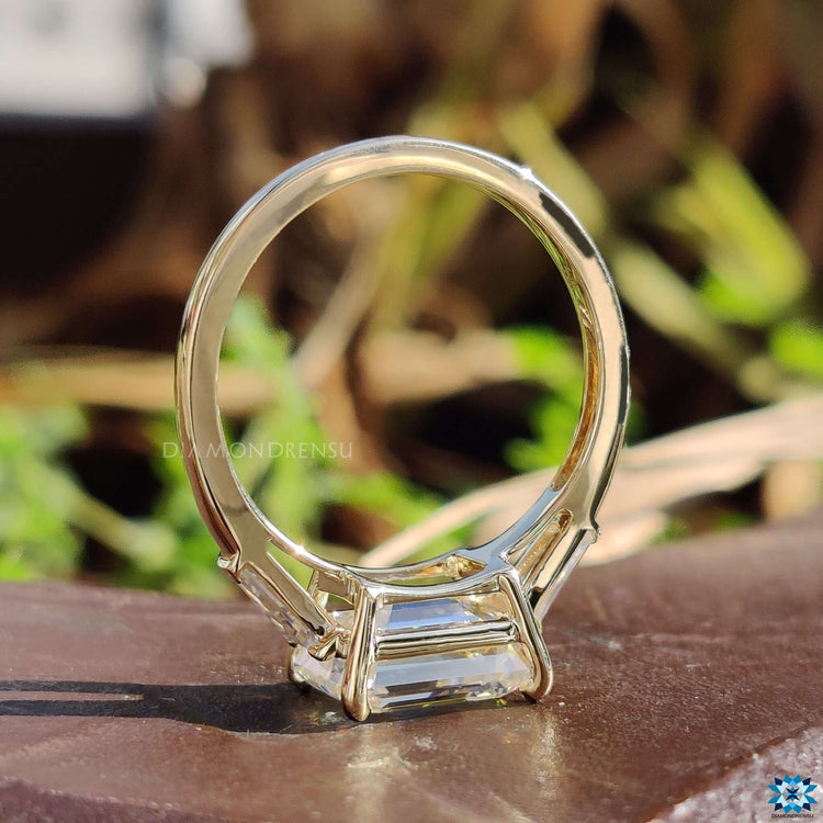 Gold ring with emerald and baguette cut stones.
