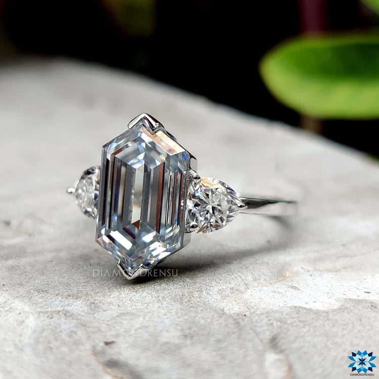 Unique hexagon moissanite ring with side trillion stones.
