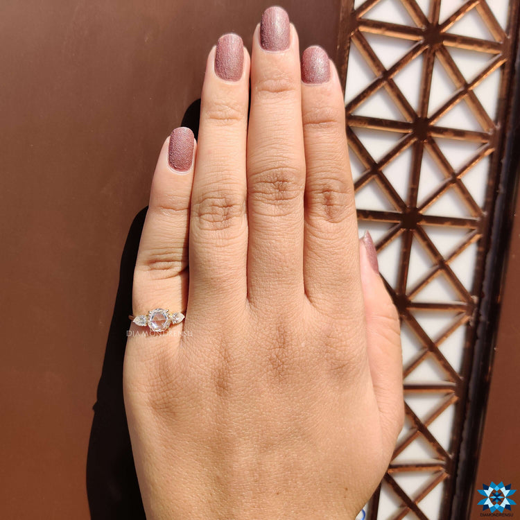 Prong set round rose cut moissanite ring with side stones.
