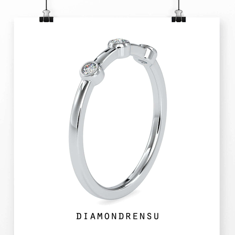 White gold bezel set wedding band with handmade finish.
