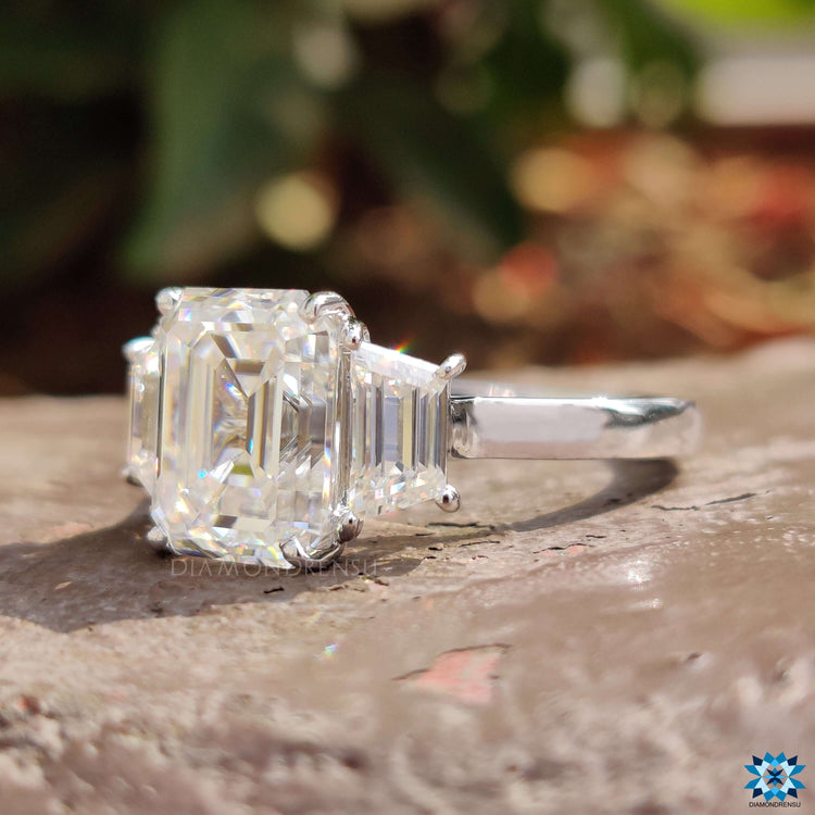 Cathedral setting ring with three moissanite stones in white gold.
