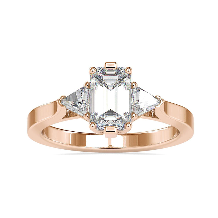 UK engagement ring with emerald cut and trillion sides.
