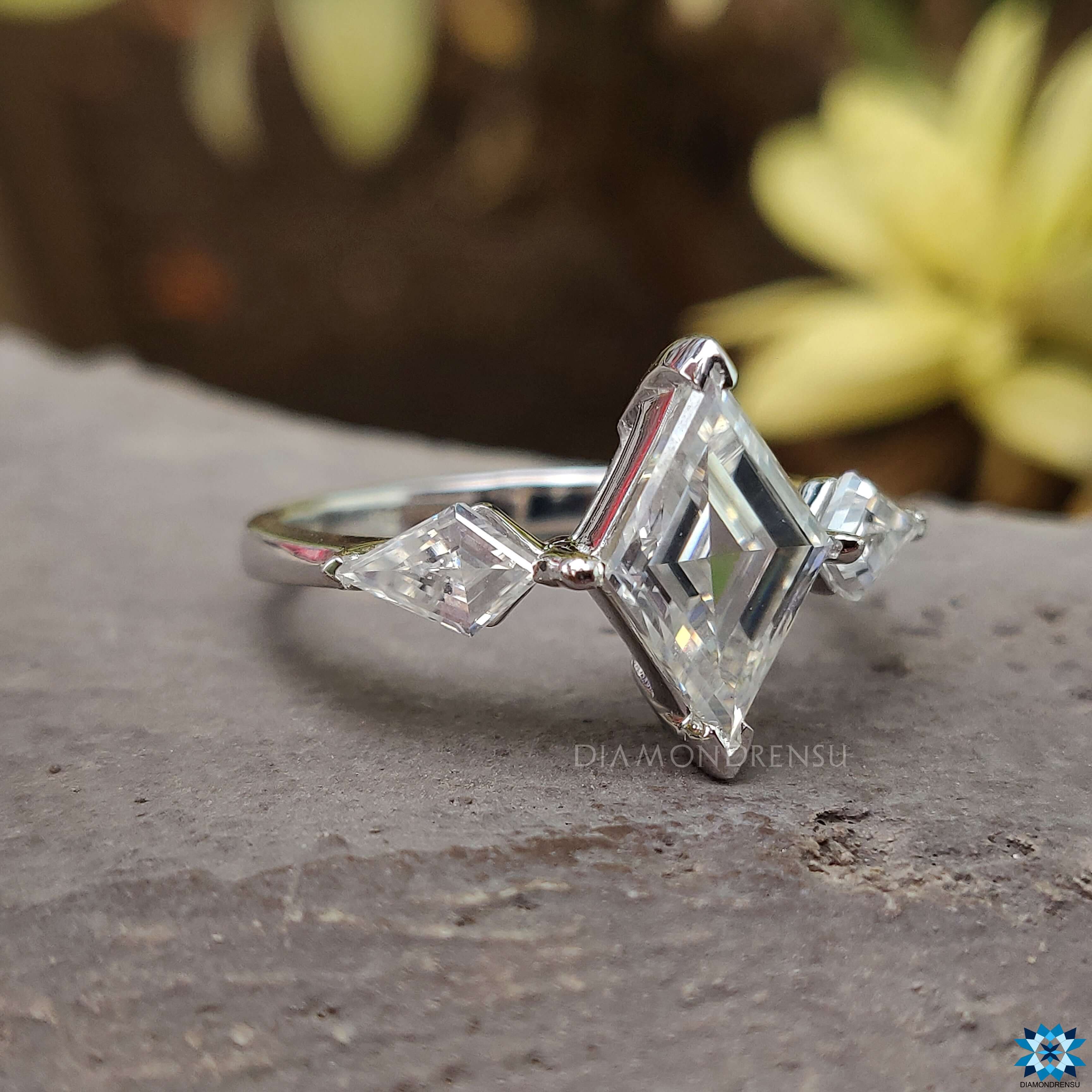 Kite cut side stone ring with 3 stone moissanite centre stones.