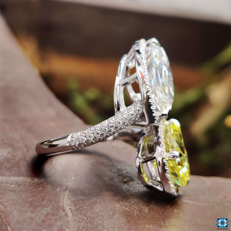 Handmade engagement ring with pear-shaped moissanites and halo detail.
