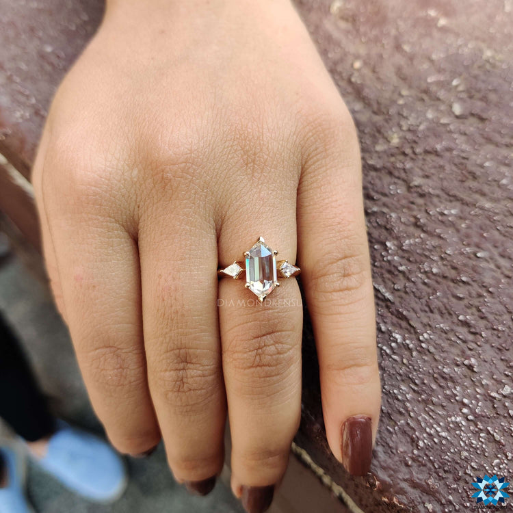 Kite cut side stones on a moissanite engagement ring.
