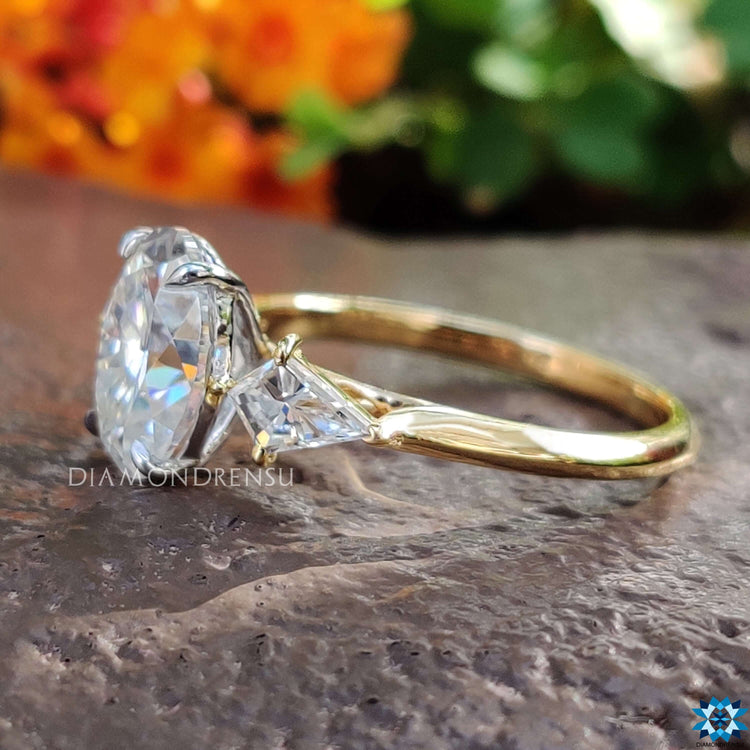 Three stone ring with oval cut center stone.
