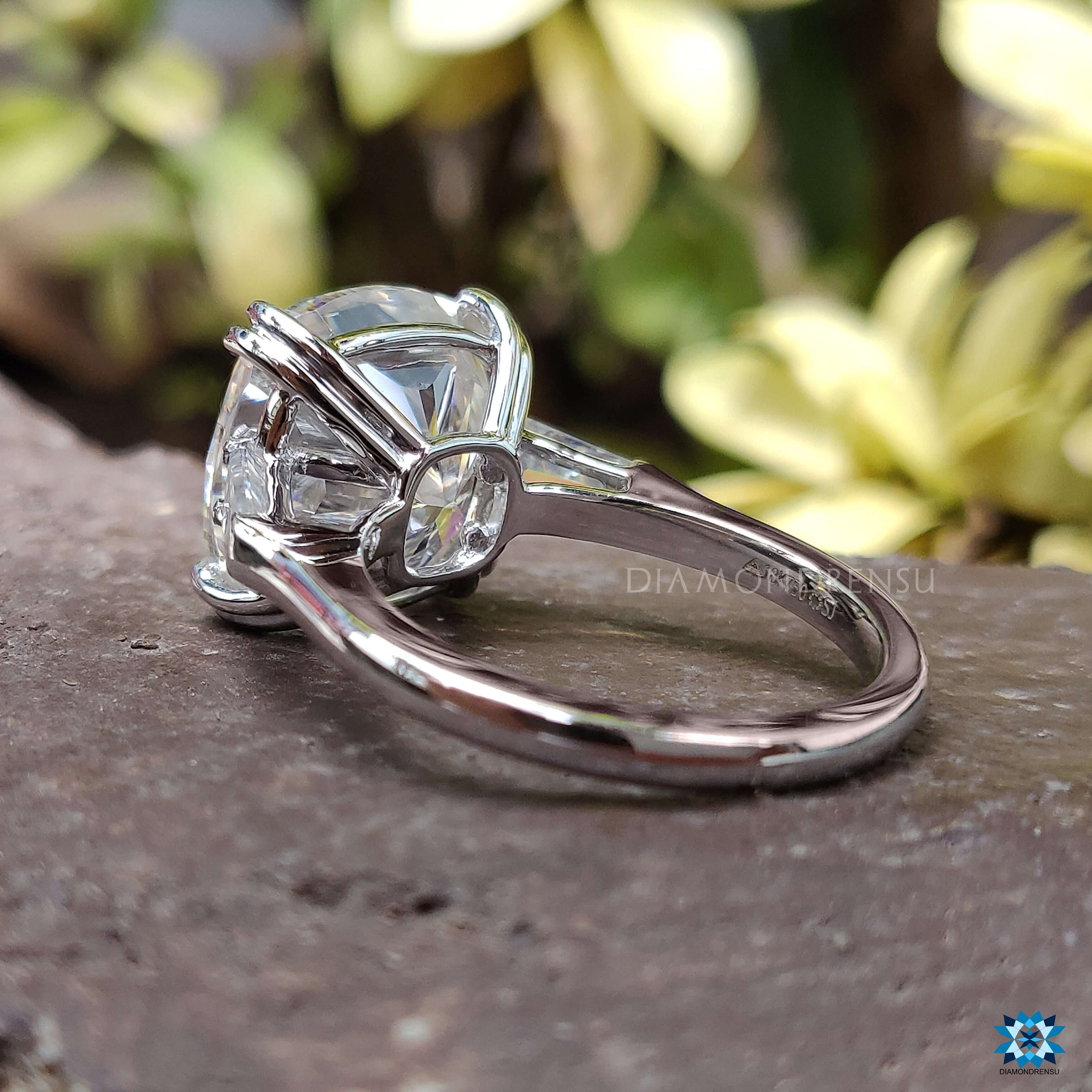 Cushion cut moissanite ring with tapered baguette ring accents for elegance.