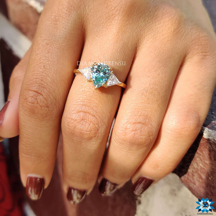 Handmade jewelry featuring cyan blue pear cut moissanite.
