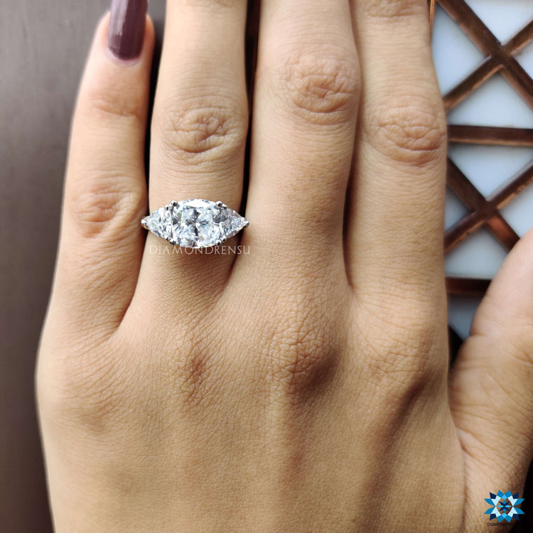 Elegant three stone engagement ring with moissanite gems.
