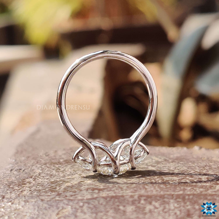 Custom engagement ring with round three stone design.
