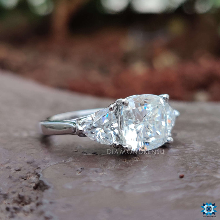 Handmade three stone moissanite ring in white gold.
