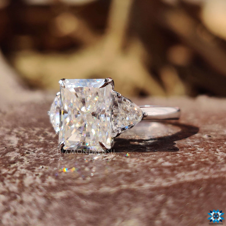 Handmade three stone ring with radiant and trillion moissanites.

