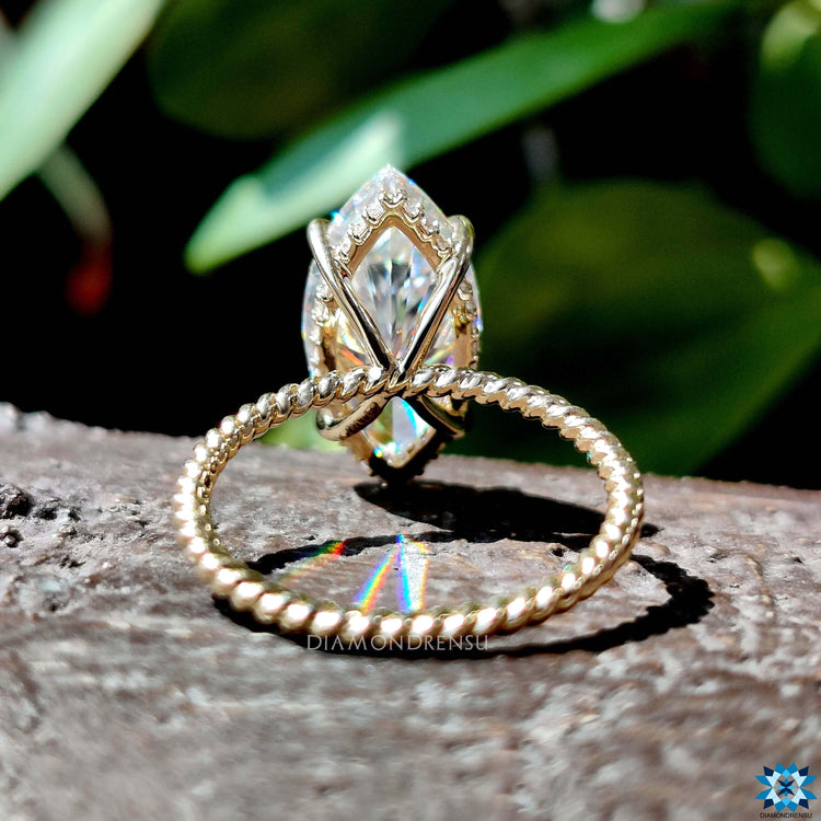 Yellow gold ring featuring marquise moissanite.
