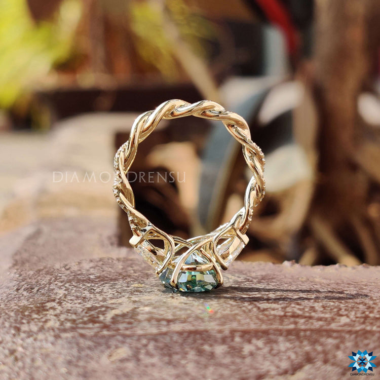 Oval moissanite ring set in yellow gold with a 4 prong claw setting.
