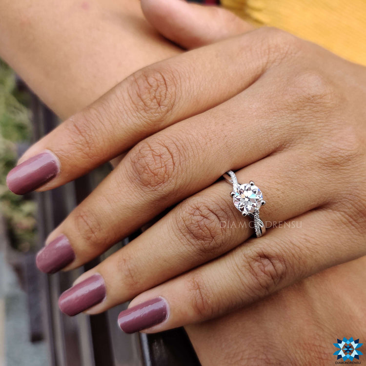 White gold twisted band moissanite pave engagement ring.
