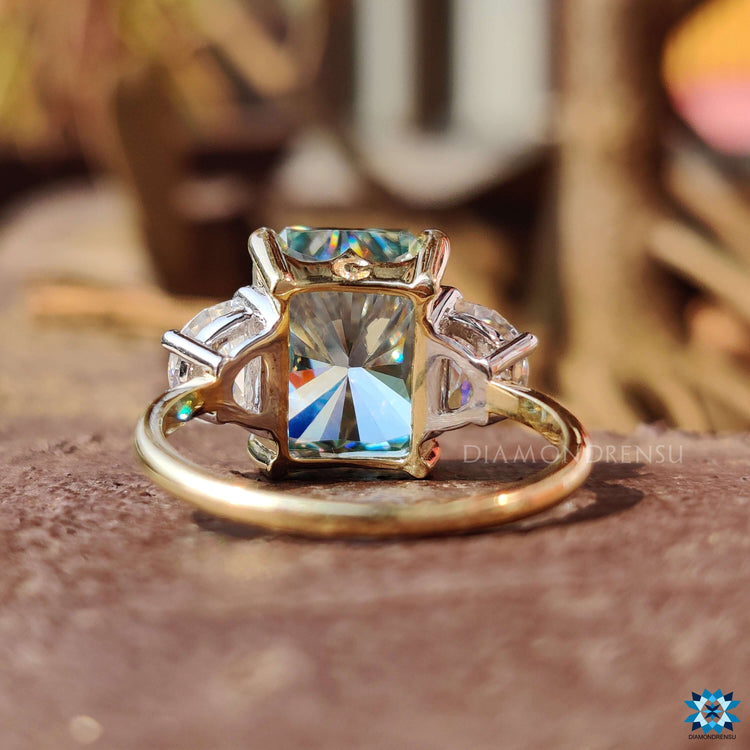 Handmade engagement ring with three moissanite stones.
