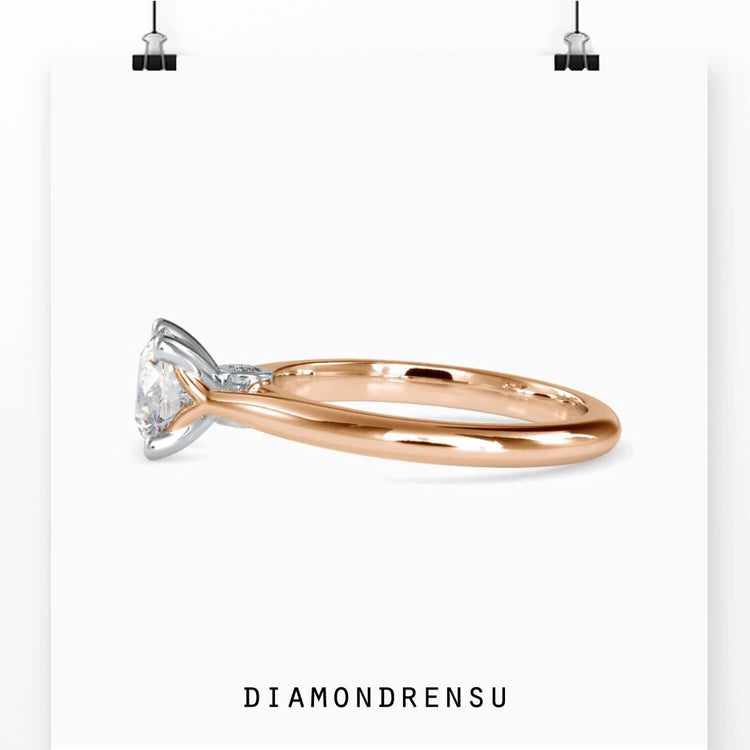 Yellow gold ring with round cut in prong setting.
