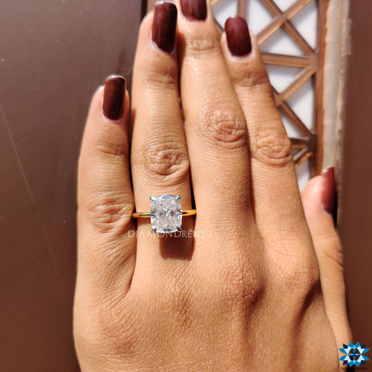Prong set solitaire ring with elongated cushion center.
