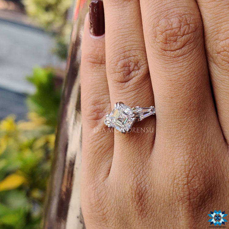 Asscher cut center stone ring with round and baguette moissanite.
