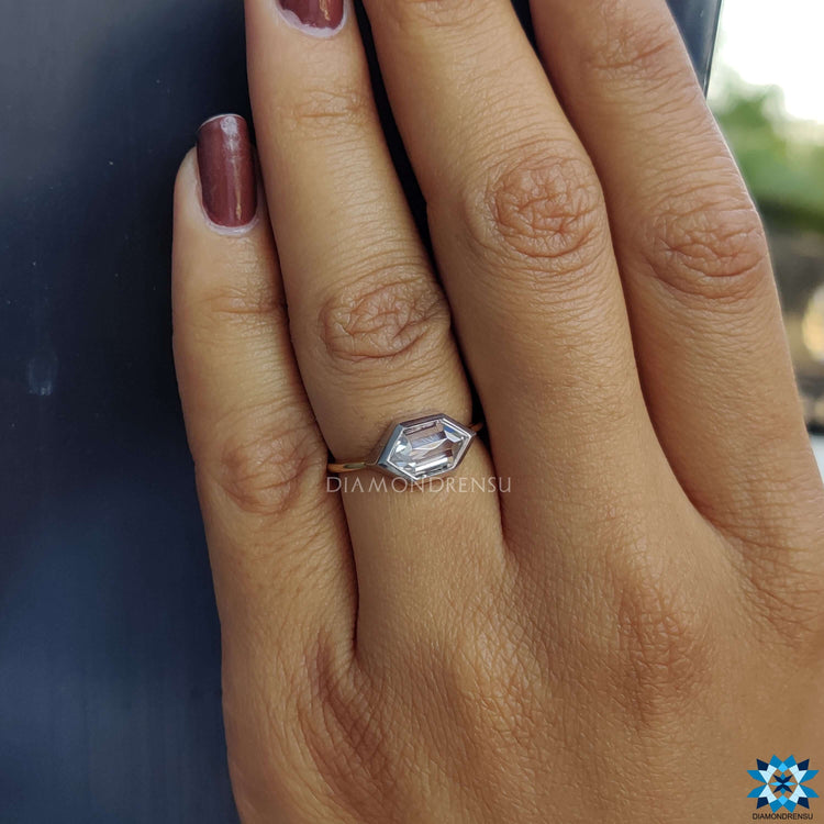 Handmade jewelry featuring two-tone bezel set engagement ring.
