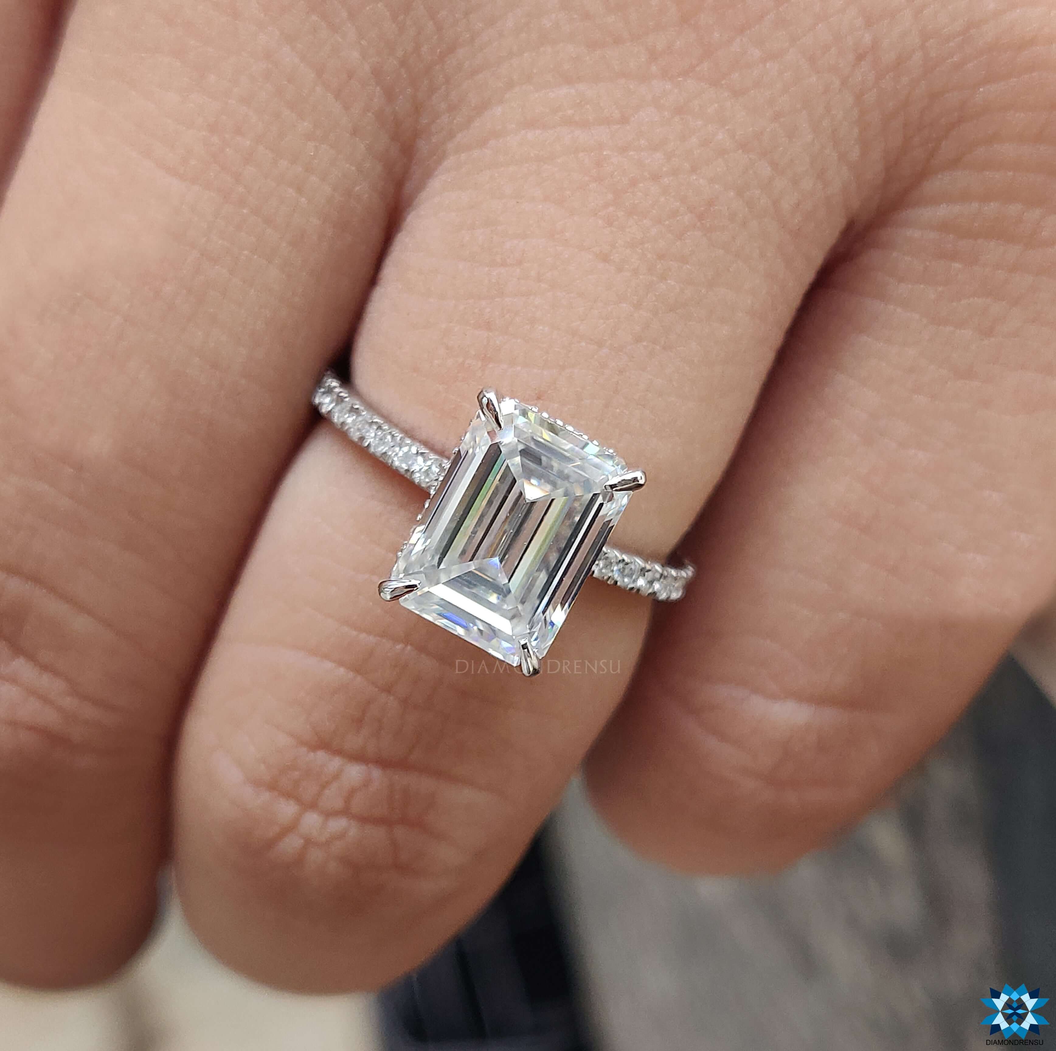 Emerald cut moissanite ring with a beautiful hidden halo moissanite ring for added brilliance.