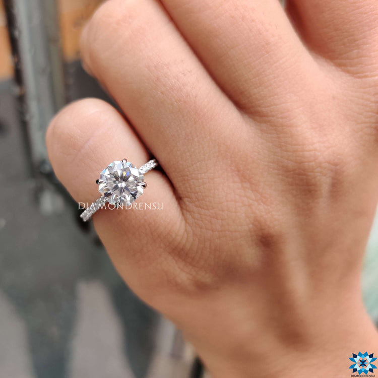 Hidden halo moissanite ring in white gold with pave band.

