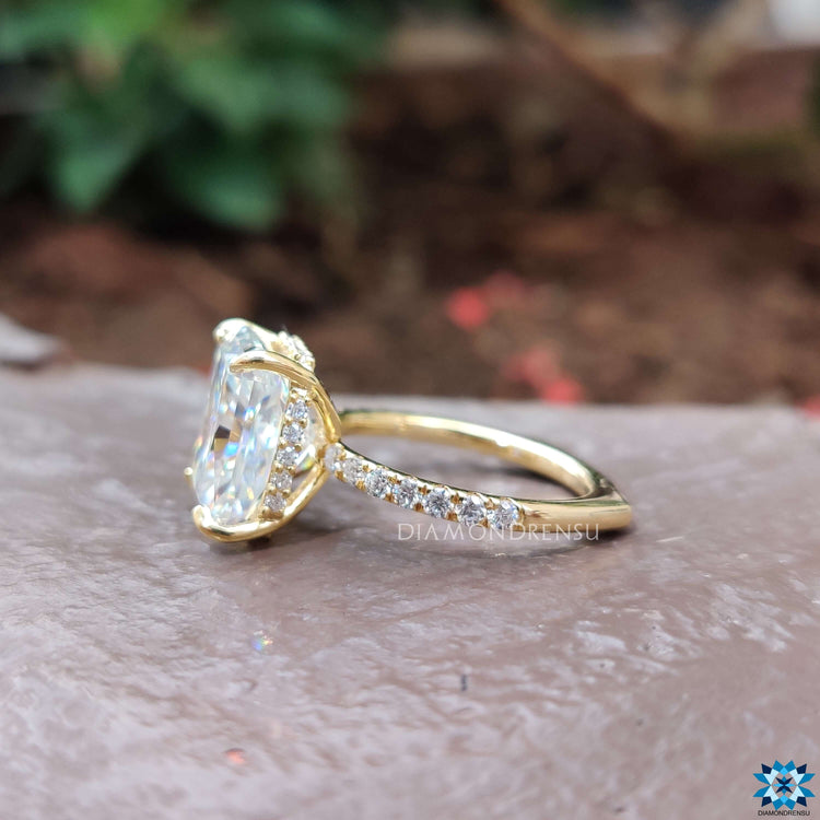 Yellow gold ring with radiant cut moissanite and hidden halo.
