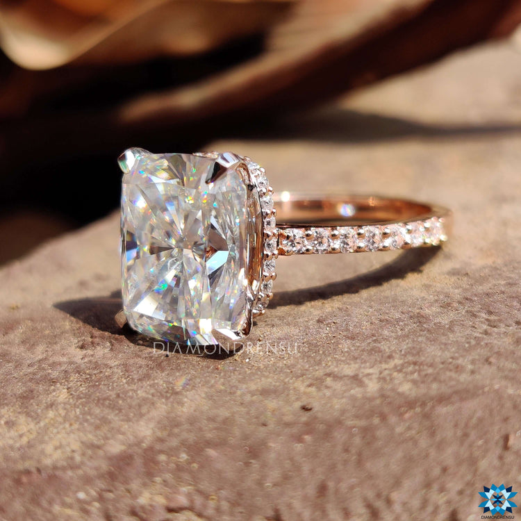White and rose gold ring with elongated cushion center.
