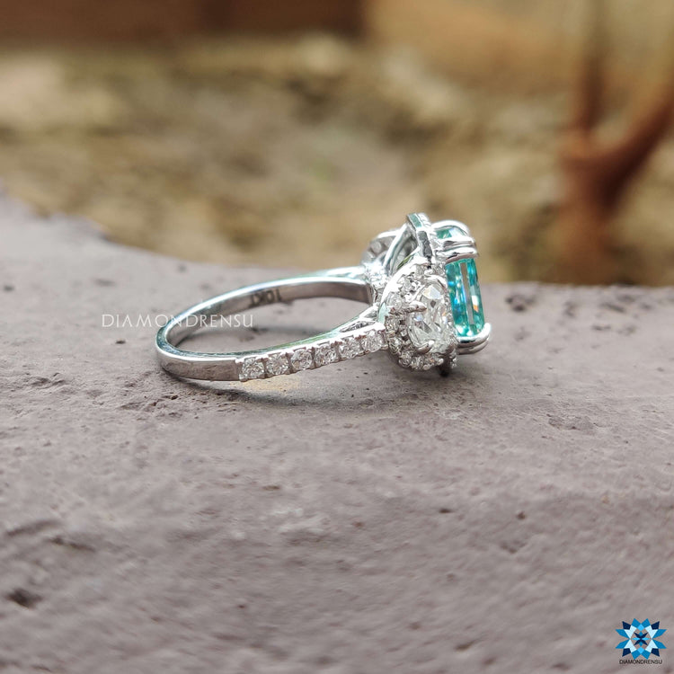 White gold ring with radiant moissanite and half moon sides.

