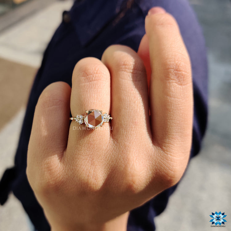 Custom engagement ring in yellow gold with round moissanite accents.
