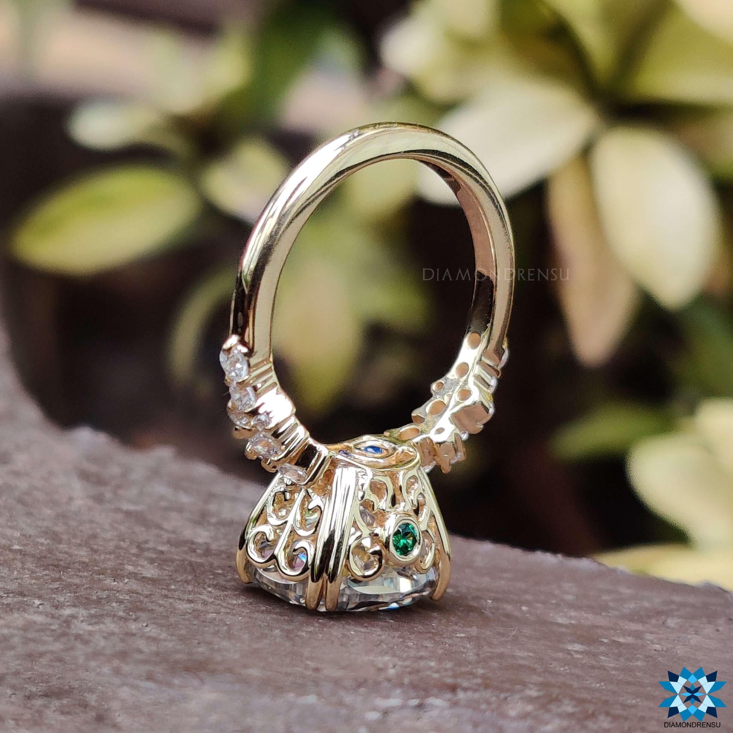 East west moissanite ring featuring round side stone engagement ring accents.