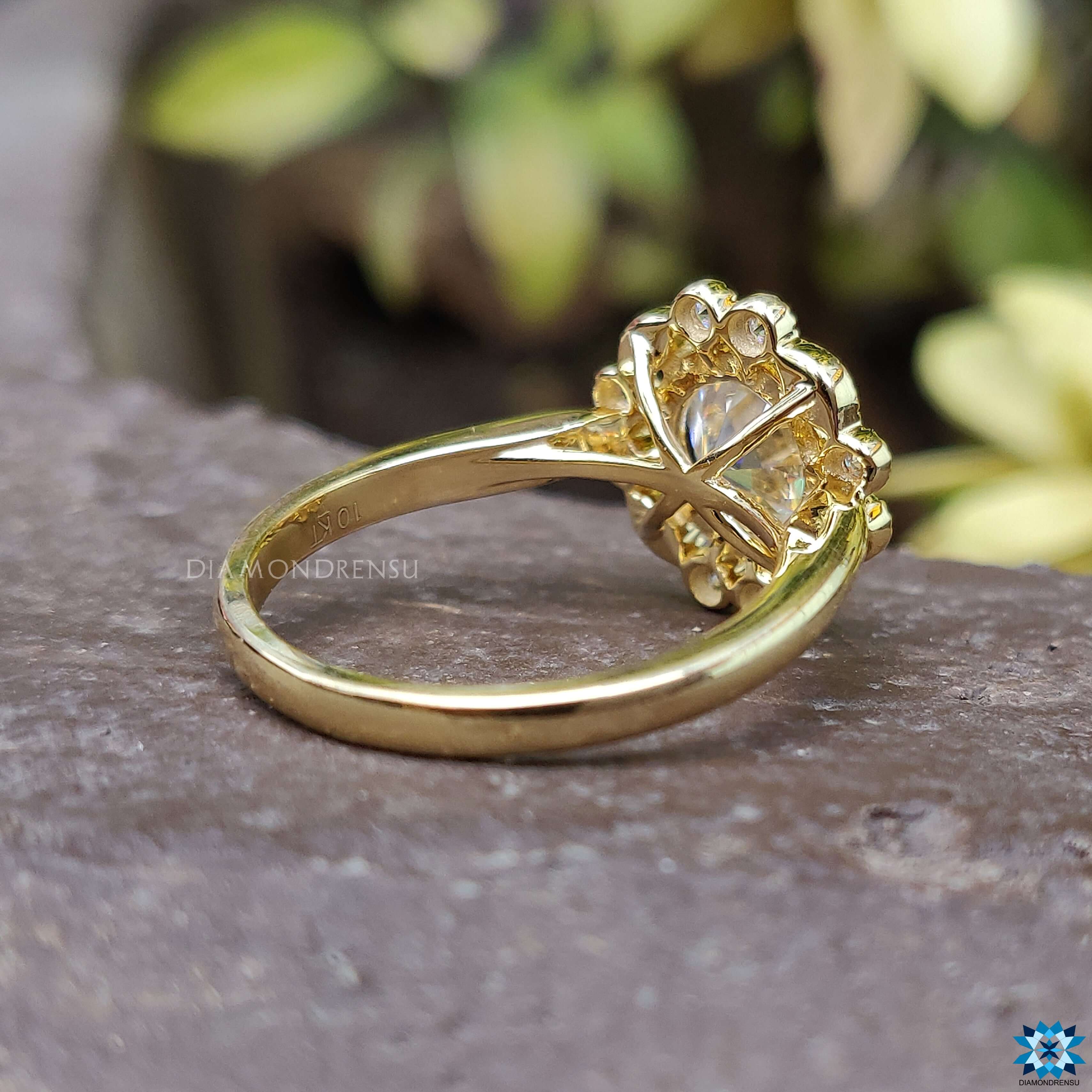 Moissanite yellow gold ring featuring a round brilliant cut centre stone.