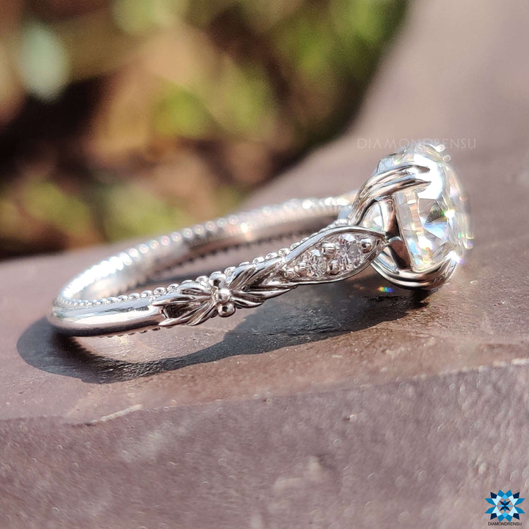 White gold oval moissanite ring with handcrafted detailing.
