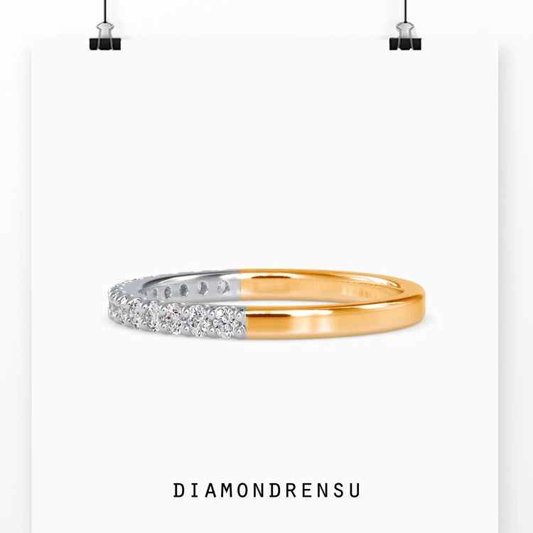 Handmade gold wedding band with prong set diamonds.

