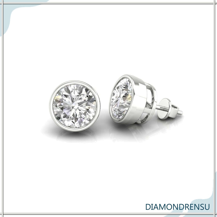 Diamond stud earrings with polished bezel finish.

