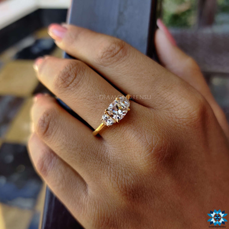Yellow gold three stone engagement ring with half moon sides.
