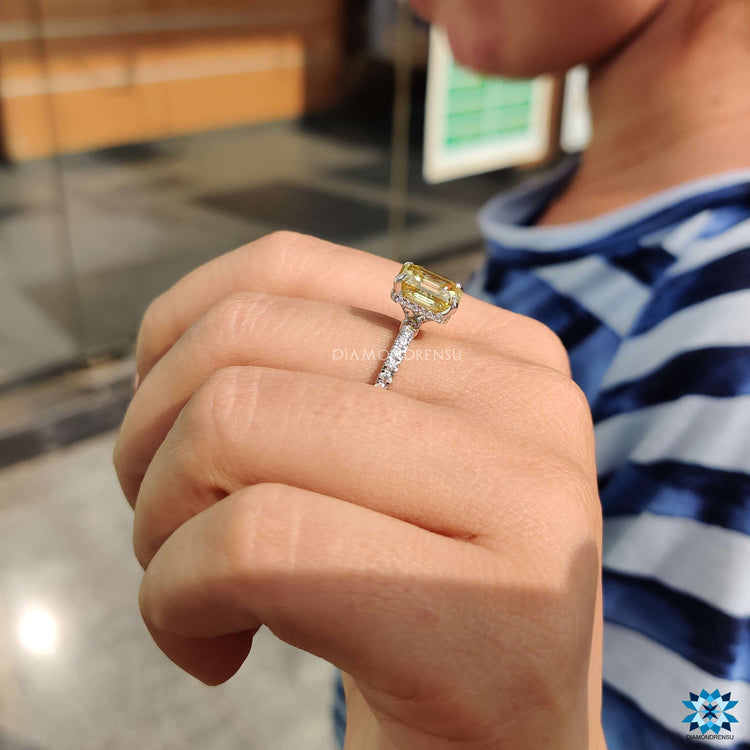 Custom moissanite ring in white gold with yellow center stone.

