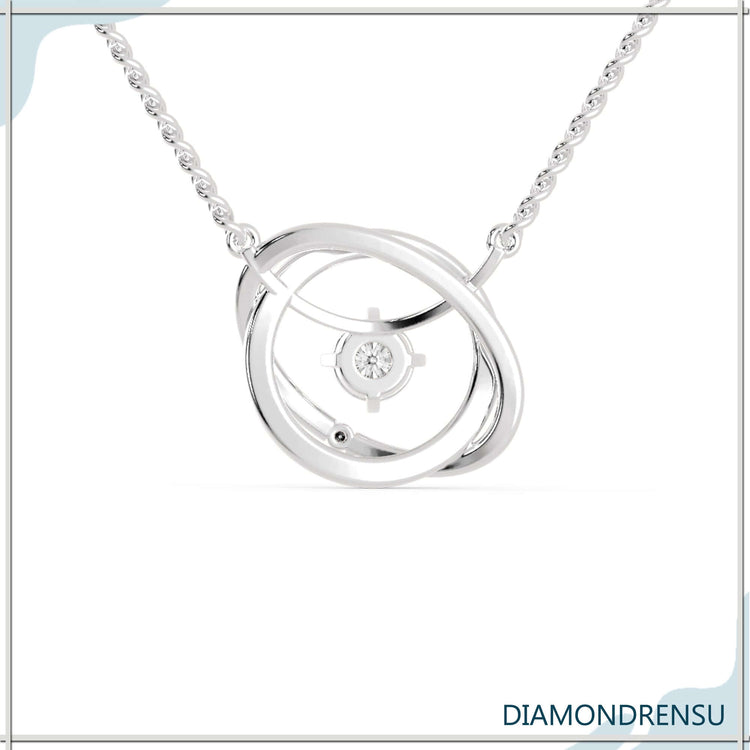 Round cut diamond pendant with interlocking gold chain feature.

