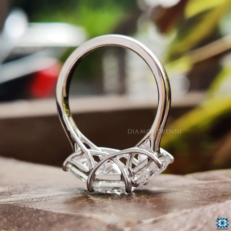 White gold ring featuring three moissanite stones.
