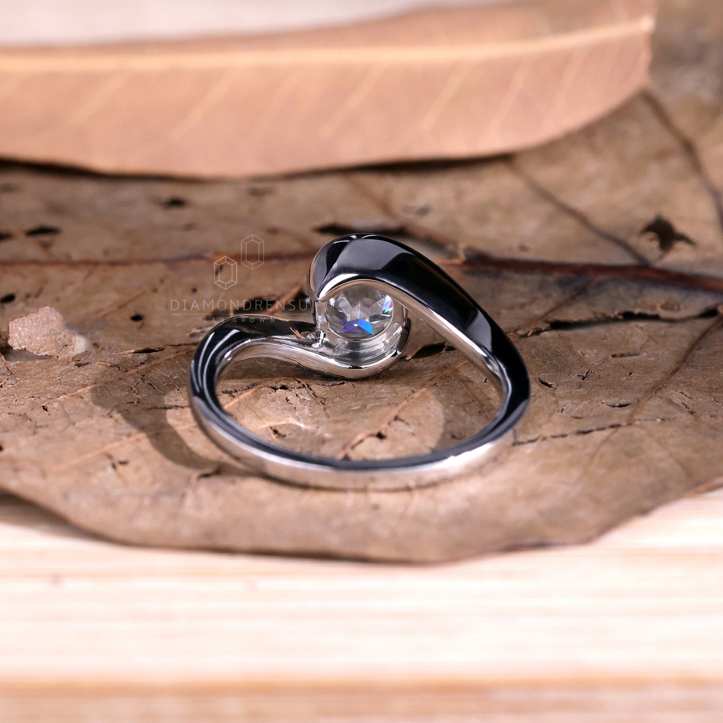 Handmade bypass setting ring featuring a lab grown diamond.