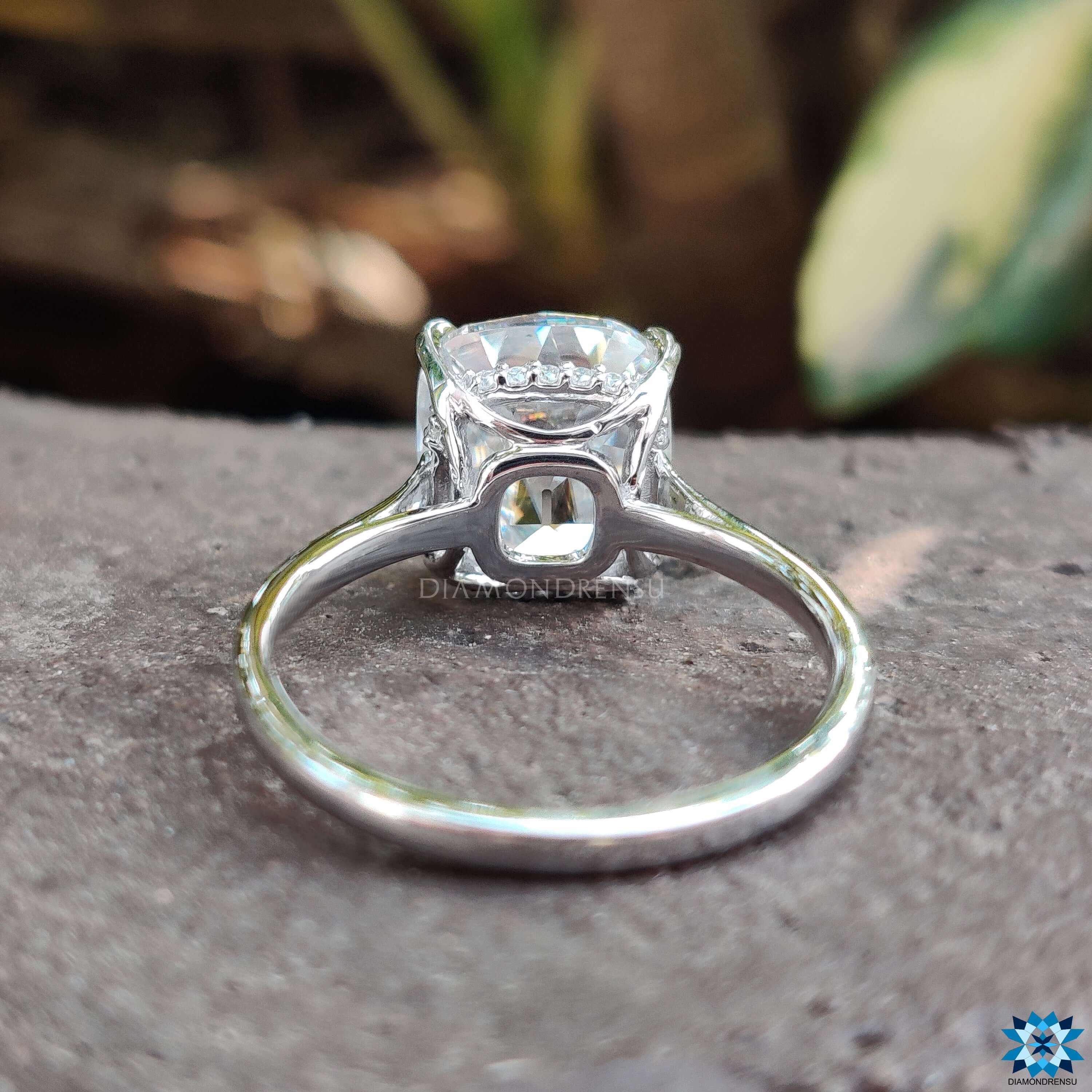 Double prong setting holding a beautiful cushion cut moissanite ring in a secure design.