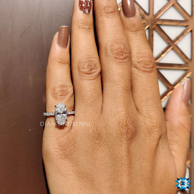 White gold ring with round cut side stones and hidden halo.
