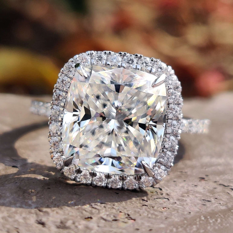 Cushion moissanite engagement ring with halo setting.
